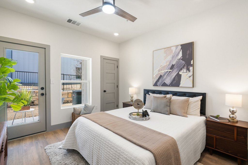 Construction workers discussing blueprints in a comfortable living space provided by CHC Rentals in Austin, TX